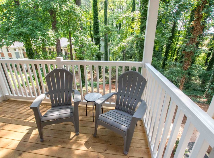 large deck or patio space. Two patio chairs.